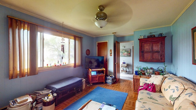 living room with ornamental molding and a ceiling fan