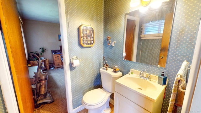 bathroom with toilet and vanity