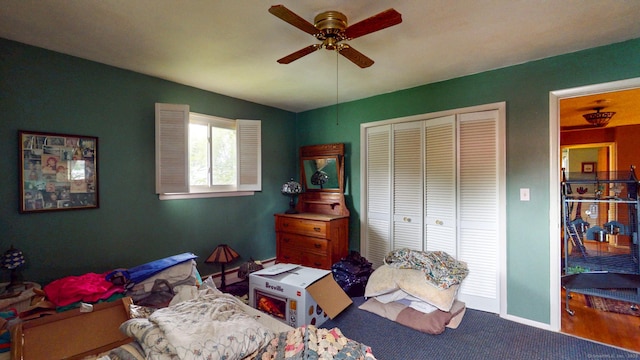 carpeted bedroom with a closet, ceiling fan, and baseboards