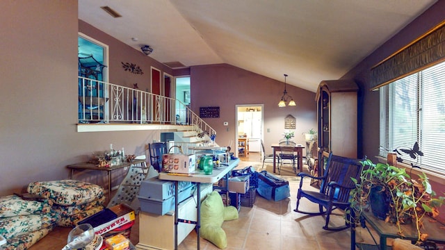 tiled living area with lofted ceiling and stairs