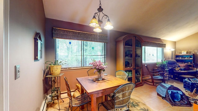 dining room with healthy amount of natural light, a chandelier, vaulted ceiling, light tile patterned flooring, and baseboards