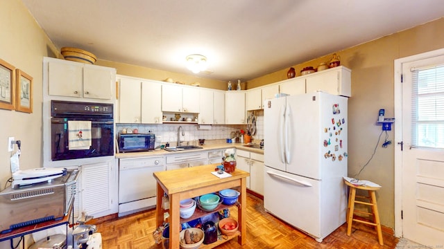 kitchen with black appliances, a sink, light countertops, decorative backsplash, and open shelves