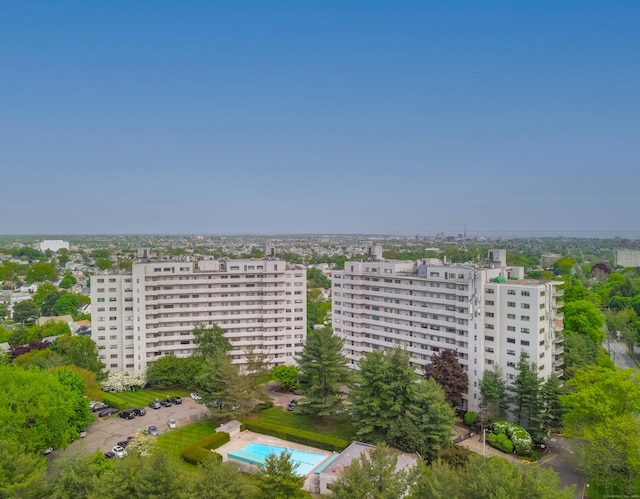 view of urban area featuring a pool and apartment complex / building