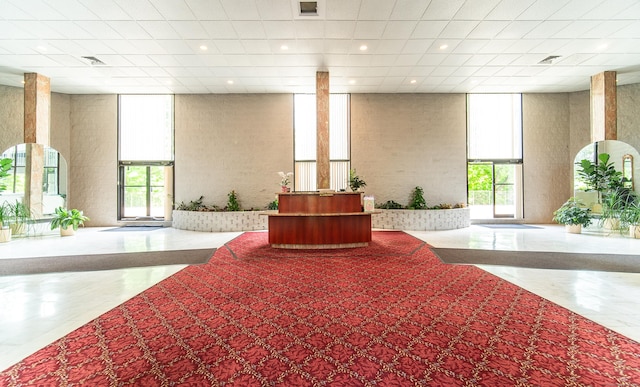 building lobby featuring a high ceiling and expansive windows
