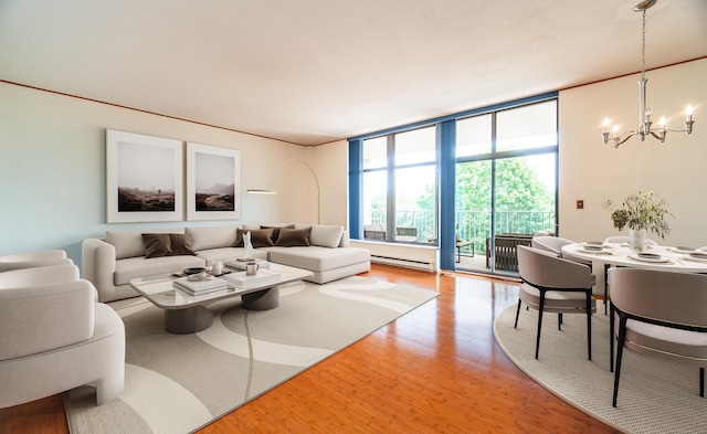 living area featuring a chandelier, wood finished floors, floor to ceiling windows, and baseboard heating