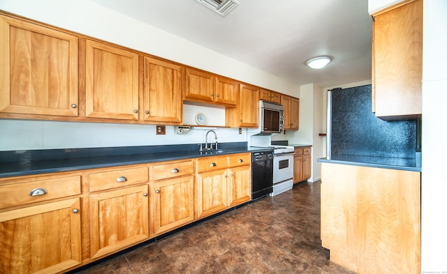 kitchen featuring stainless steel microwave, dishwasher, dark countertops, range, and a sink