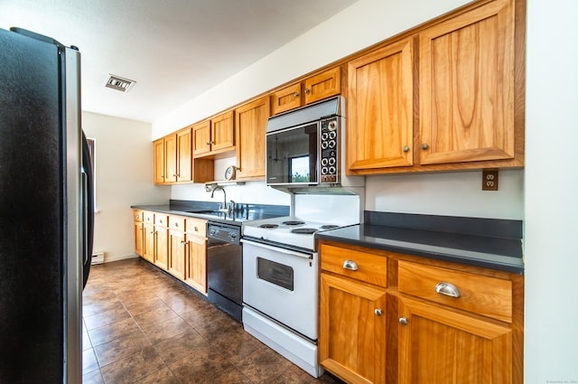 kitchen featuring freestanding refrigerator, black dishwasher, dark countertops, a sink, and electric range