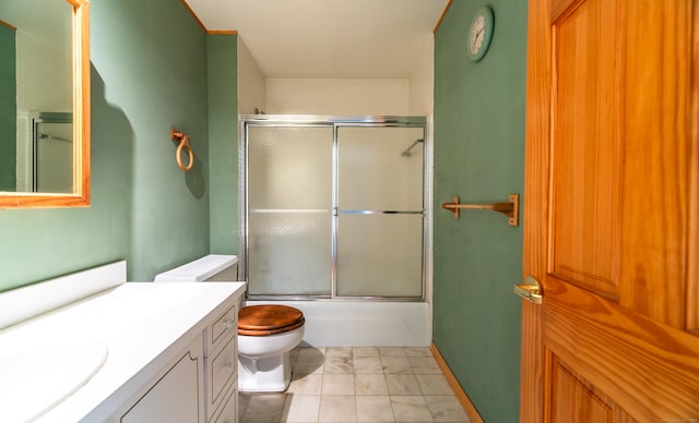 full bathroom with toilet, vanity, and combined bath / shower with glass door