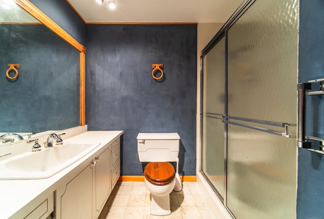 full bath featuring a stall shower, toilet, tile patterned floors, vanity, and baseboards
