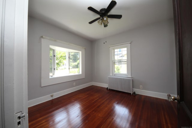 27 Ann St, West Haven, CT 06516 - empty room featuring radiator heating unit, wood finished floors, baseboards, and ceiling fan