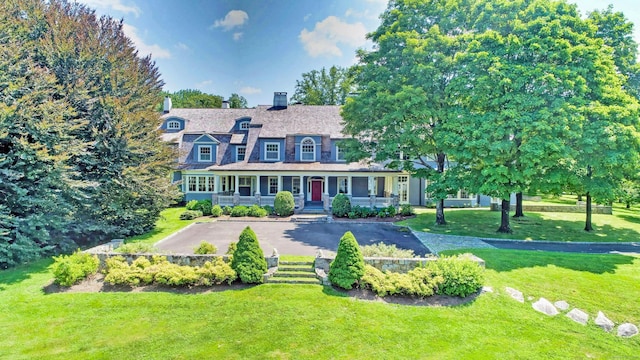27 Country Club Rd, Ridgefield, CT 06877 - view of front of house with a chimney, a front lawn, and covered porch