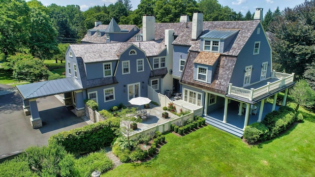 27 Country Club Rd, Ridgefield, CT 06877 - rear view of house with a chimney and a wooden deck