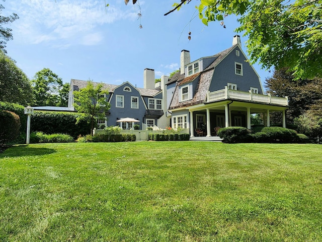 27 Country Club Rd, Ridgefield, CT 06877 - back of house with a chimney, a gambrel roof, and a yard