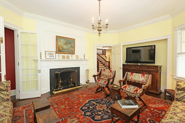 27 Country Club Rd, Ridgefield, CT 06877 - living room with a fireplace with flush hearth, ornamental molding, wood finished floors, a chandelier, and stairway