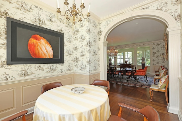 27 Country Club Rd, Ridgefield, CT 06877 - dining area featuring arched walkways, ornate columns, a chandelier, wallpapered walls, and a wainscoted wall