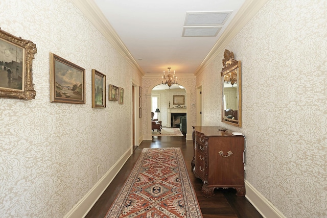 27 Country Club Rd, Ridgefield, CT 06877 - corridor with dark wood finished floors, arched walkways, ornamental molding, a chandelier, and wallpapered walls