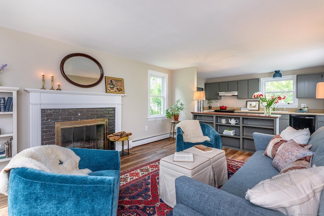 87 Canaan Rd Apt 2F, Salisbury, CT 06068 - living area with a baseboard heating unit, wood finished floors, and a fireplace