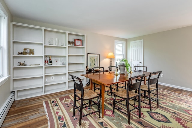 87 Canaan Rd Apt 2F, Salisbury, CT 06068 - dining space featuring a baseboard heating unit and dark wood-style flooring