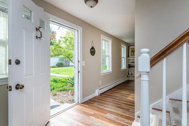 87 Canaan Rd Apt 2F, Salisbury, CT 06068 - entrance foyer featuring a baseboard radiator, light wood-style flooring, stairway, and healthy amount of natural light