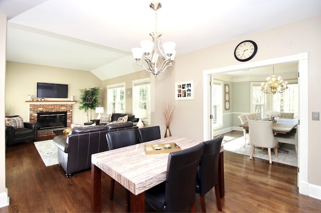 56 Grouse Ln, Woodbridge, CT 06525 - dining area with a chandelier, dark wood finished floors, vaulted ceiling, a fireplace, and baseboards
