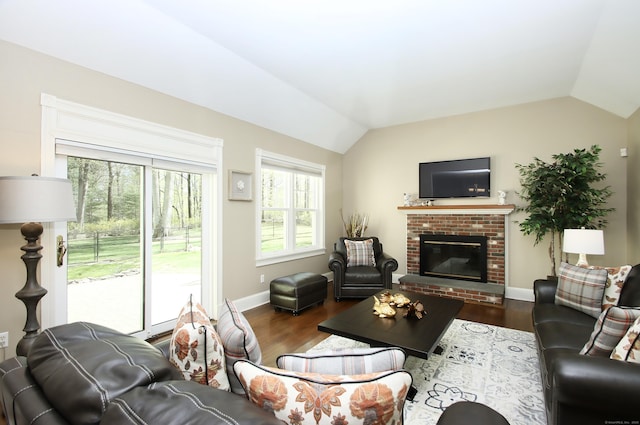 56 Grouse Ln, Woodbridge, CT 06525 - living area featuring vaulted ceiling, wood finished floors, baseboards, and a brick fireplace