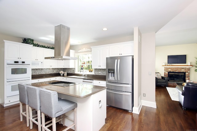 56 Grouse Ln, Woodbridge, CT 06525 - kitchen with white appliances, island exhaust hood, dark wood finished floors, and recessed lighting