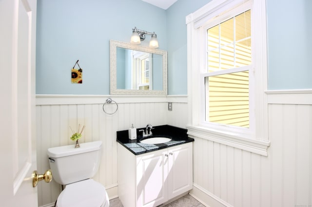 56 Grouse Ln, Woodbridge, CT 06525 - bathroom with wainscoting, toilet, vanity, and a decorative wall