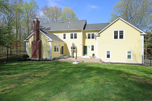 56 Grouse Ln, Woodbridge, CT 06525 - back of property with entry steps, a chimney, and a patio area