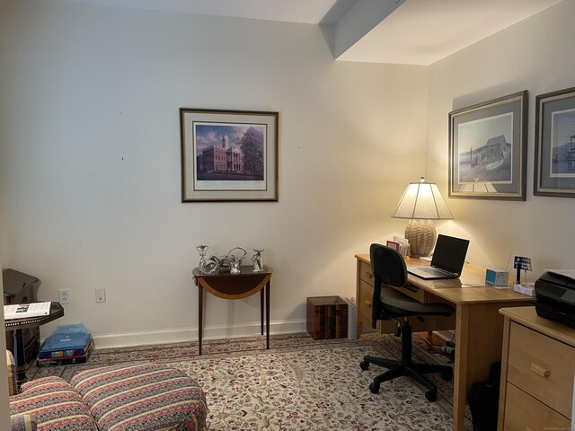 office area featuring baseboards and carpet