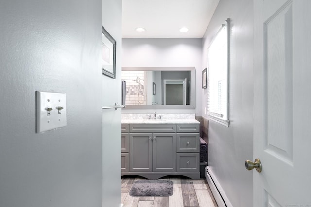 153 Mountain Rd, Cheshire, CT 06410 - bathroom featuring a baseboard radiator, wood finished floors, vanity, and baseboards