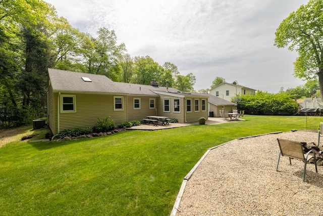 153 Mountain Rd, Cheshire, CT 06410 - rear view of house with central AC, a patio area, a lawn, and a chimney