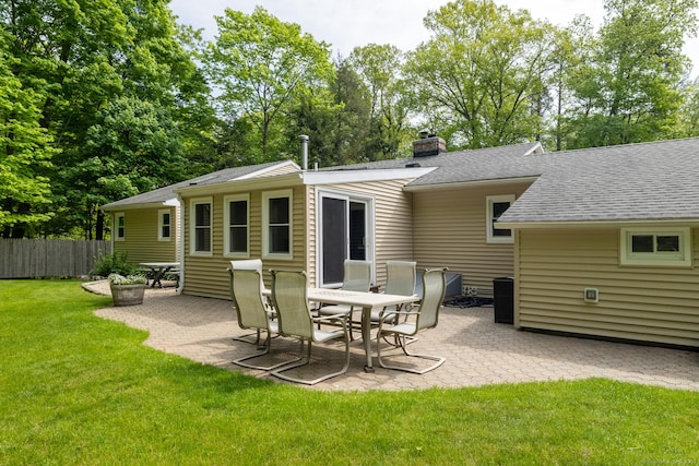 153 Mountain Rd, Cheshire, CT 06410 - back of house featuring a patio area, a shingled roof, a chimney, and view of wooded area