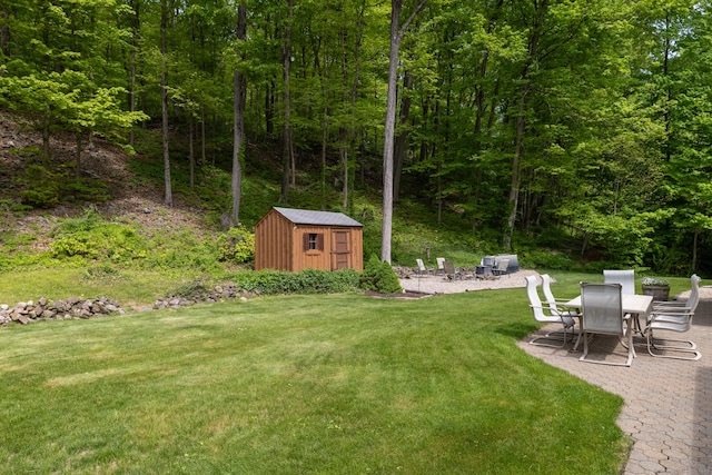 153 Mountain Rd, Cheshire, CT 06410 - view of grassy yard featuring a shed, a patio area, an outbuilding, and a wooded view