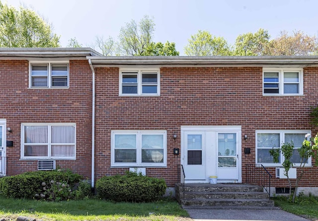 view of property with entry steps and brick siding