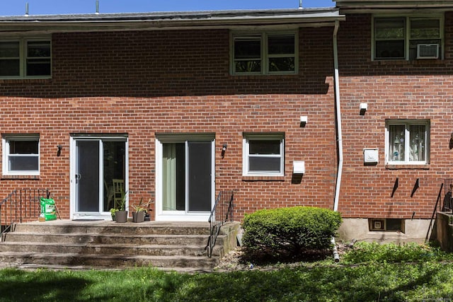 back of house featuring brick siding