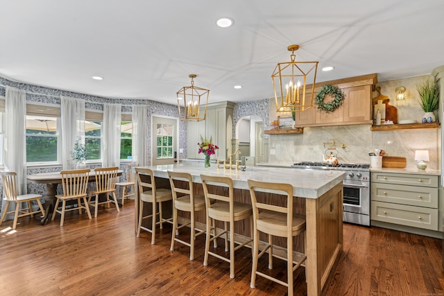 12 Rob Rider Rd, Redding, CT 06896 - kitchen featuring high end stainless steel range oven, light countertops, a chandelier, a center island with sink, and tasteful backsplash
