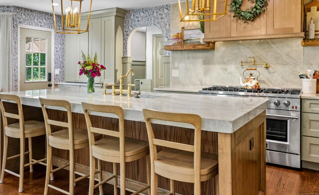12 Rob Rider Rd, Redding, CT 06896 - kitchen with stainless steel stove, dark wood-type flooring, wallpapered walls, tasteful backsplash, and a sink