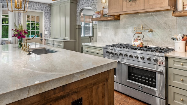 12 Rob Rider Rd, Redding, CT 06896 - kitchen with stainless steel range, light stone counters, decorative backsplash, and a sink