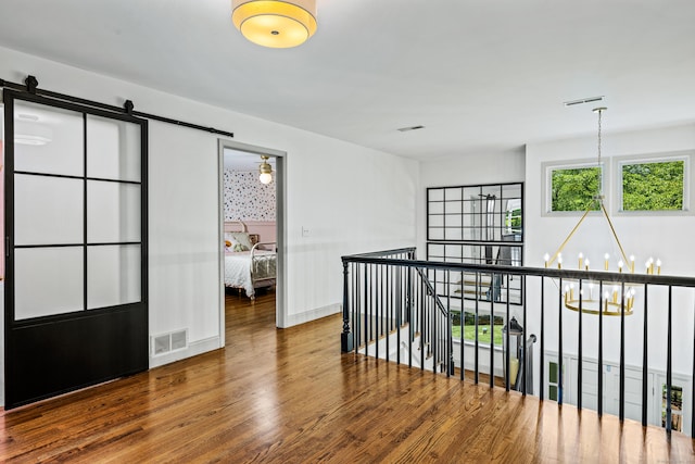 12 Rob Rider Rd, Redding, CT 06896 - corridor with an upstairs landing, a barn door, wood finished floors, and baseboards