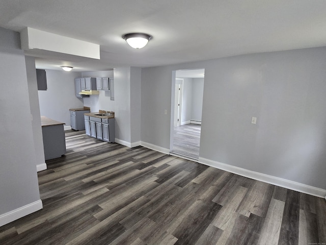 78 Tremont St, New Britain, CT 06051 - unfurnished living room with baseboards, dark wood-style floors, and a baseboard heating unit