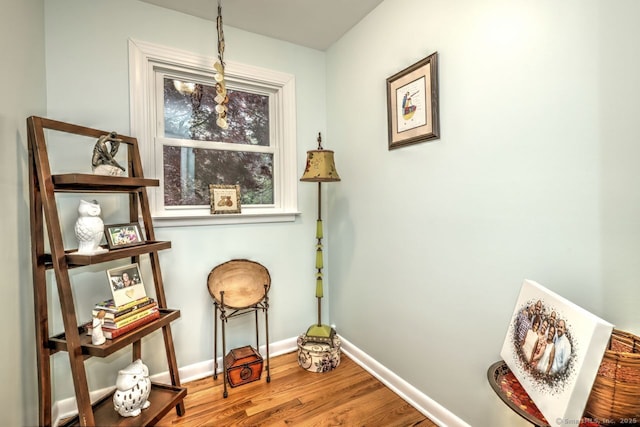 living area with wood finished floors and baseboards