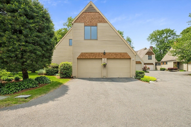 8 Cottonwood Ct Unit 8, Granby, CT 06035 - view of front of property featuring asphalt driveway and a garage
