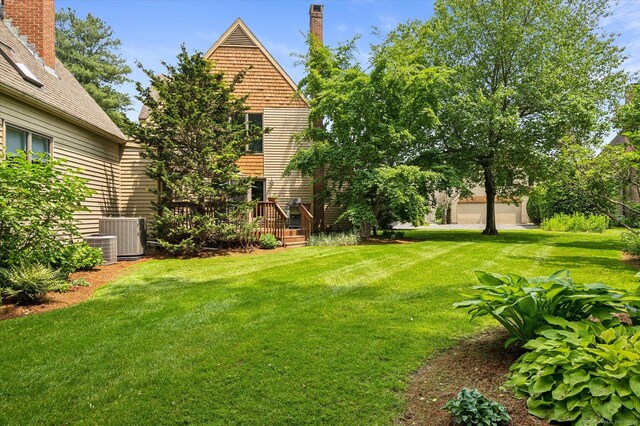 8 Cottonwood Ct Unit 8, Granby, CT 06035 - view of grassy yard featuring central air condition unit and a wooden deck