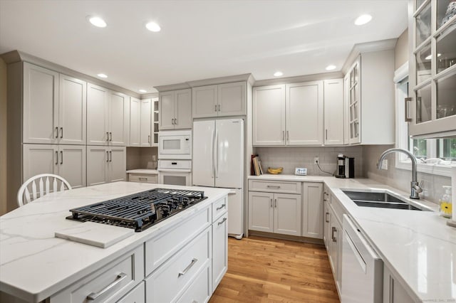 8 Cottonwood Ct Unit 8, Granby, CT 06035 - kitchen with white appliances, a sink, light stone counters, light wood finished floors, and recessed lighting