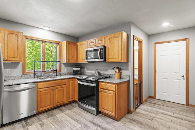 74R Green Ln, Durham, CT 06422 - kitchen with appliances with stainless steel finishes, a sink, light stone counters, light wood-style floors, and recessed lighting