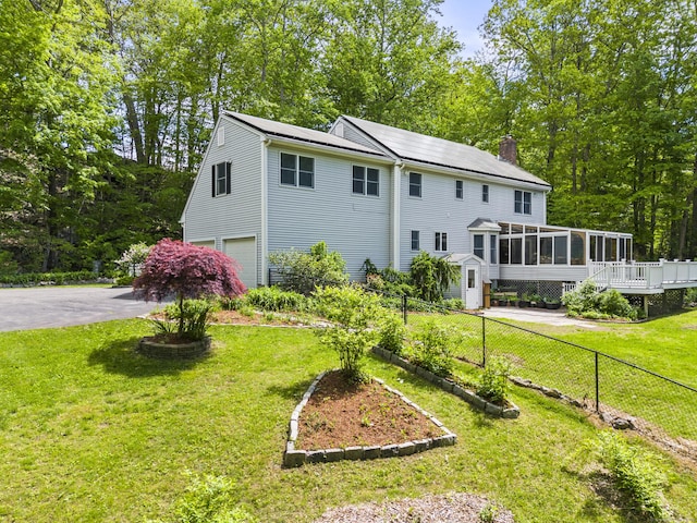 74R Green Ln, Durham, CT 06422 - view of front of house featuring a sunroom, a garage, a chimney, a wooden deck, and asphalt driveway