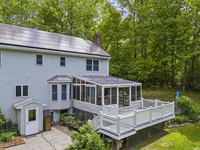 74R Green Ln, Durham, CT 06422 - rear view of property with a sunroom, solar panels, a chimney, a deck, and a patio