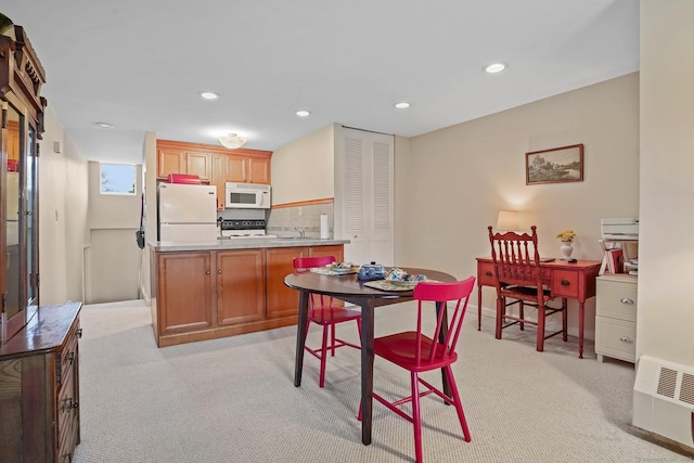 15 Ellsworth St Apt 22, Bridgeport, CT 06605 - kitchen featuring white appliances, light carpet, recessed lighting, light countertops, and a sink