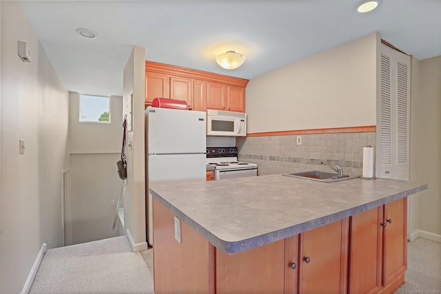 15 Ellsworth St Apt 22, Bridgeport, CT 06605 - kitchen featuring white appliances, a sink, a peninsula, baseboards, and light countertops