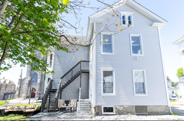 rear view of house featuring stairs